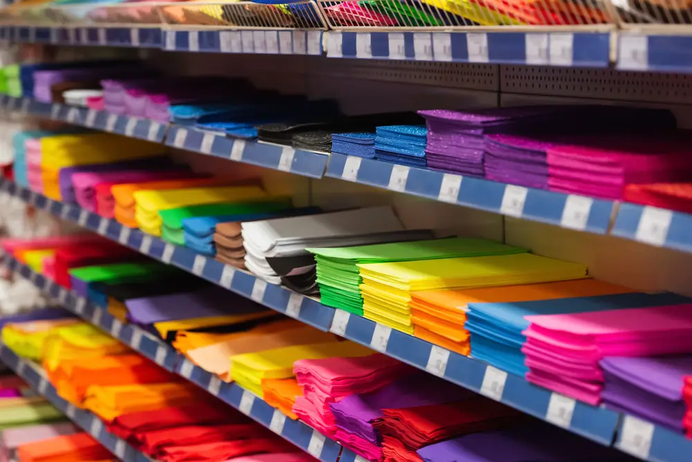 a shelf with colorful paper