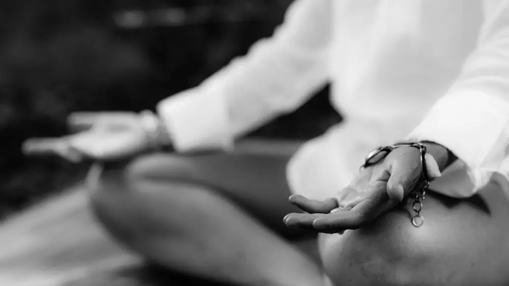 Woman meditating, balancing energy. Hands in mudra position.