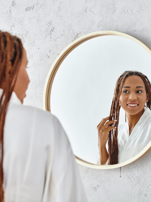 a woman looking at her reflection in the mirror