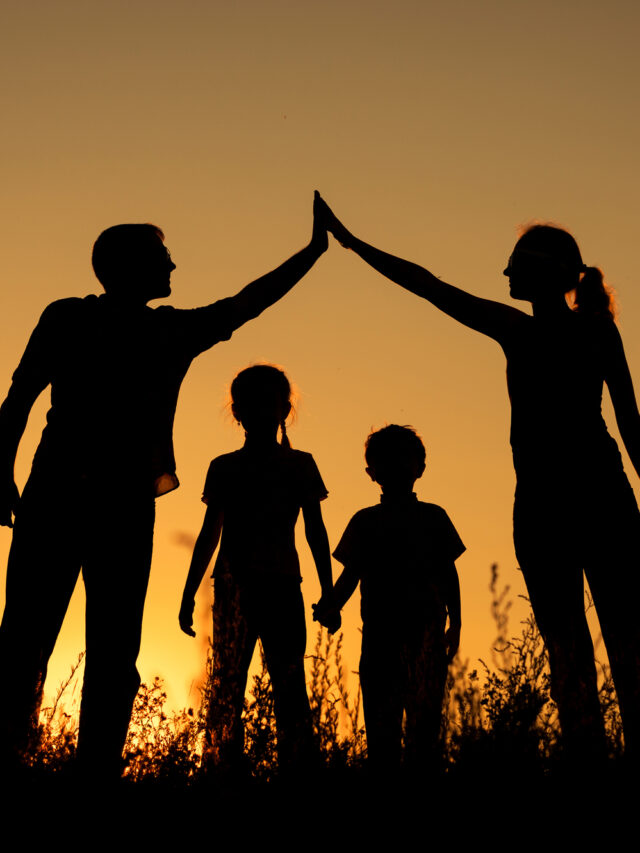 Happy family standing in the park.